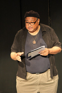 Reggie Small narrates his monologue, "God's Shoes"